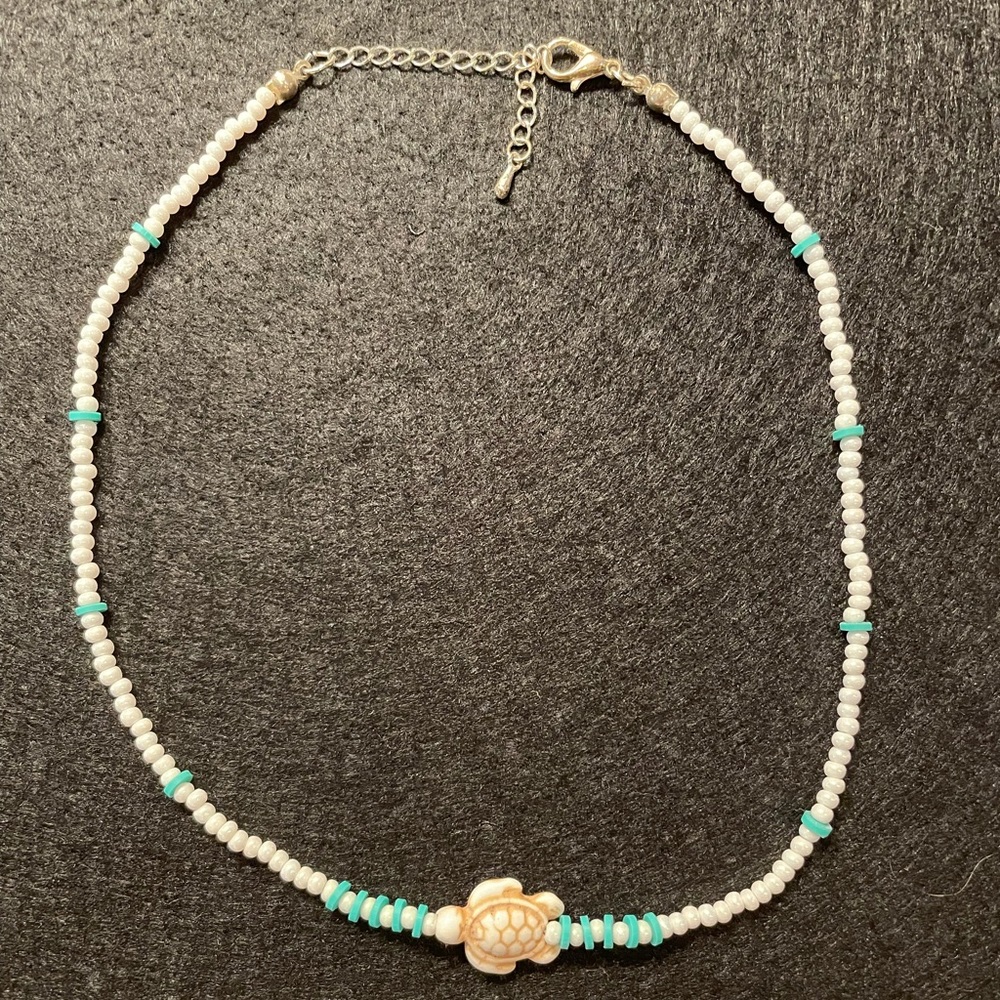 Cute beach shell necklace with turtle.